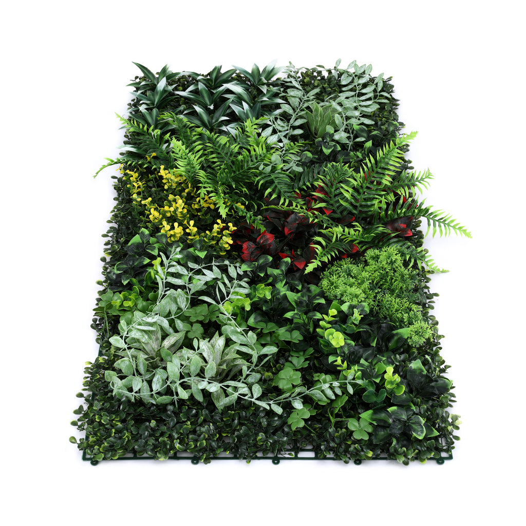 Artificial green wall panel with various green plants on a white background