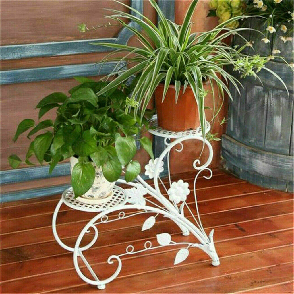 Pair of Faux Flora plant stand shelves with black metal frames and wooden shelves, ideal for displaying artificial plants.