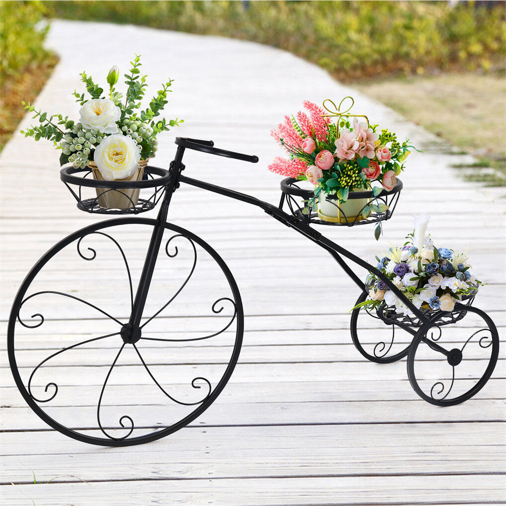 Black iron tricycle plant stand by Faux Flora holding potted artificial plants in a home and garden setting.