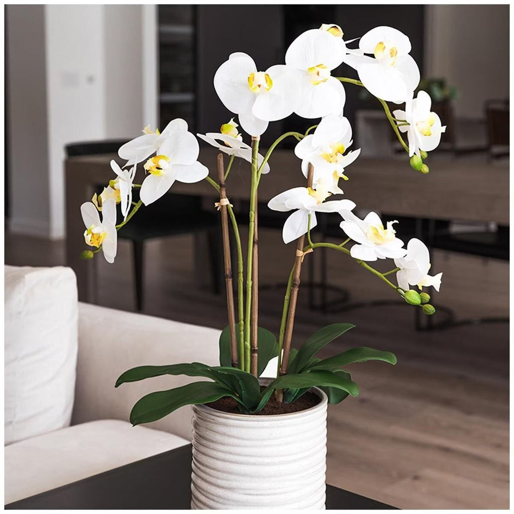 Artificial orchid in a ribbed pot, 67cm tall, from Faux Flora, suitable for home and garden decor.