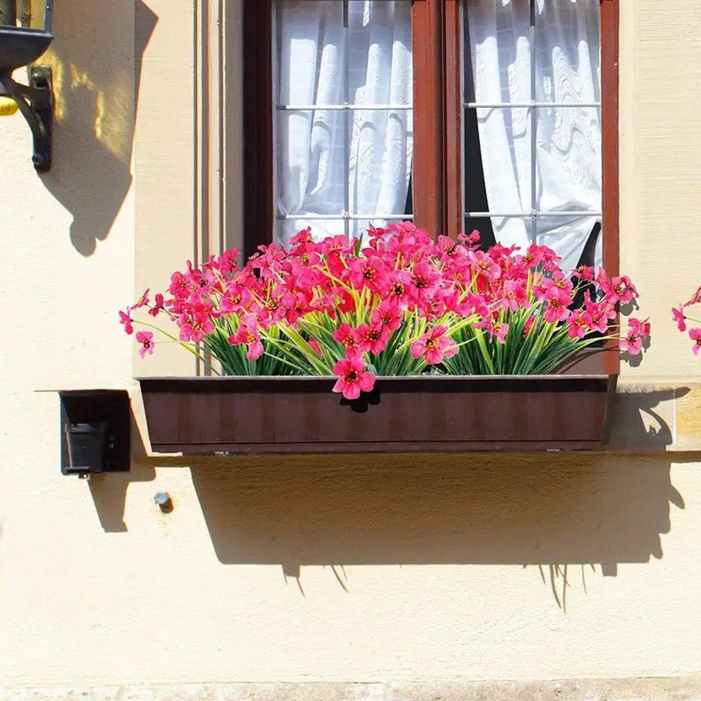 Set of twelve orange artificial spring grass flowers by Faux Flora, perfect for home and garden decor.