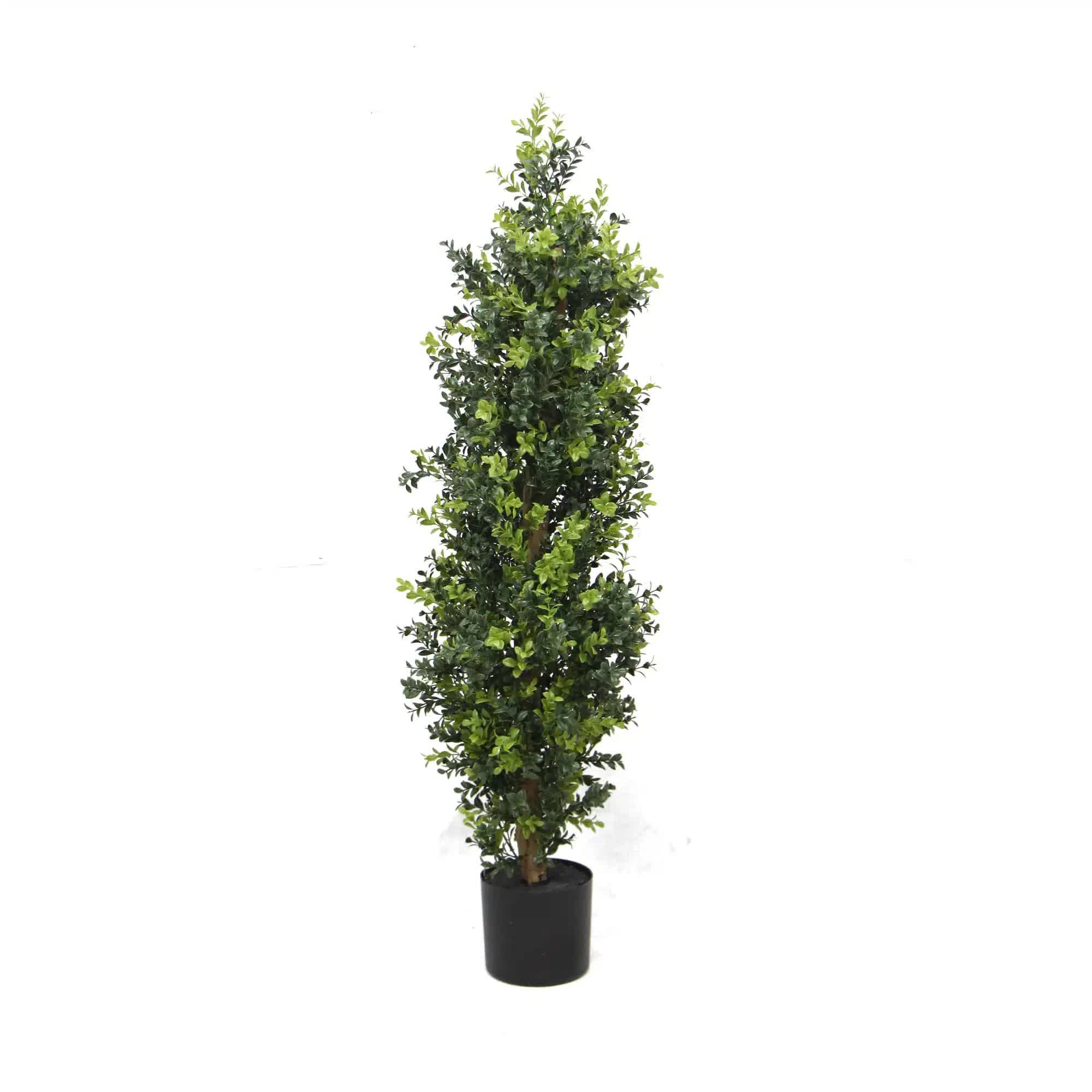 Potted artificial tree on a white background