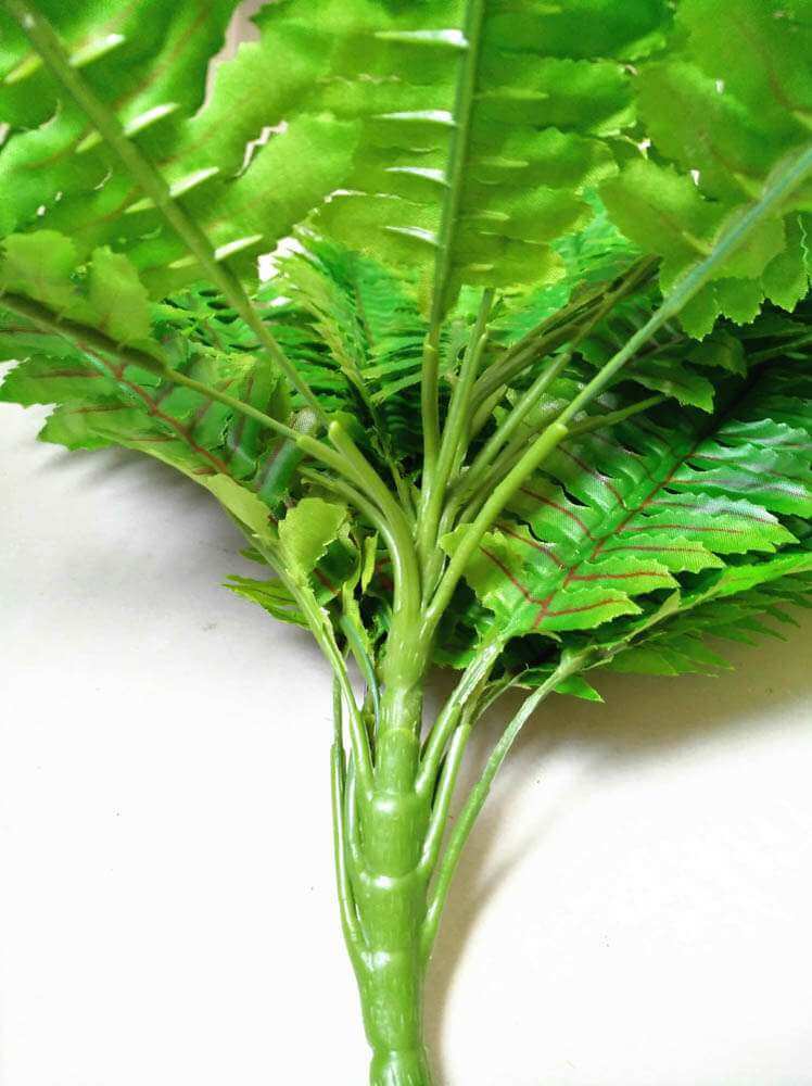 Close-up of artificial green leaves on a white background