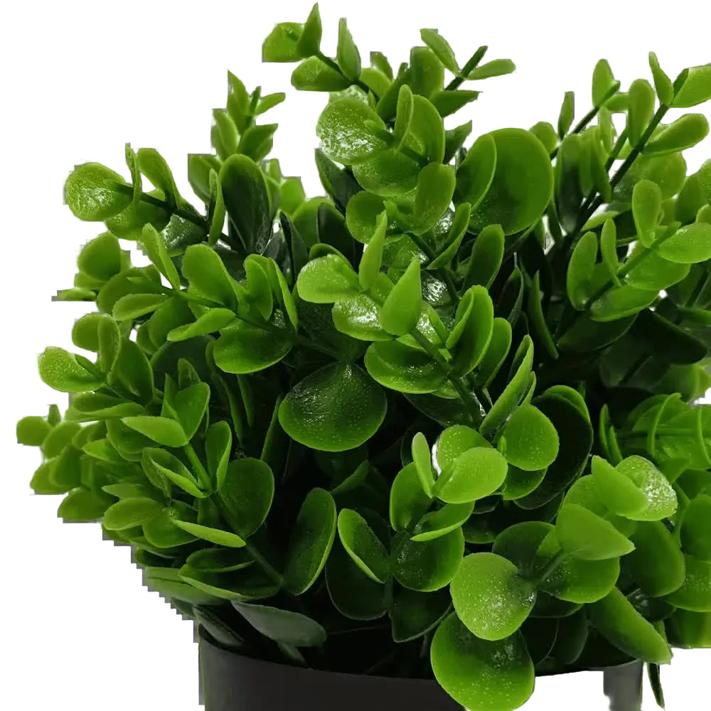 Artificial green plant in a pot on a white background