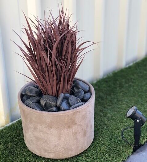 Artificial dense burgundy grass in a pot, UV resistant, 38cm tall, perfect for home and garden decor by Faux Flora.