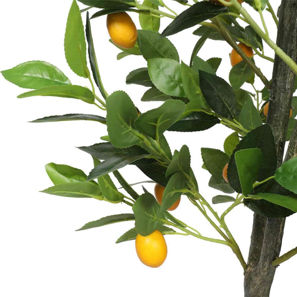 Artificial lemon tree with green leaves and yellow lemons on a white background