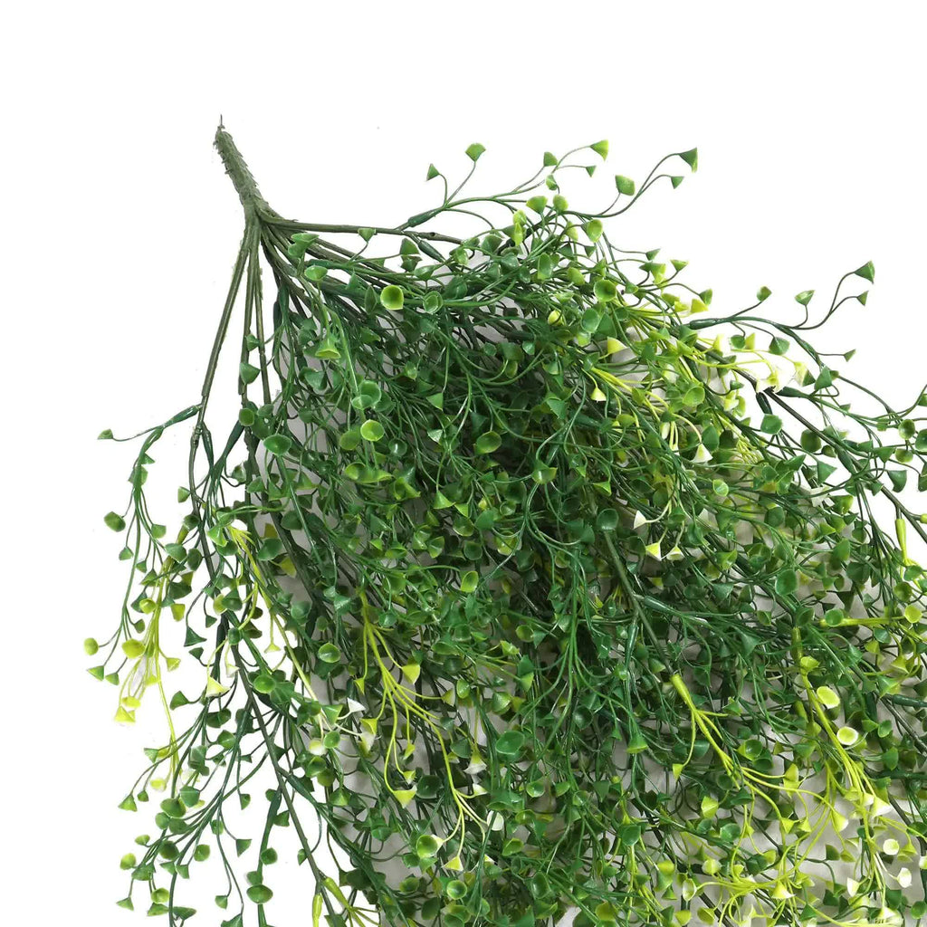 Bunch of green artificial leaves on a white background