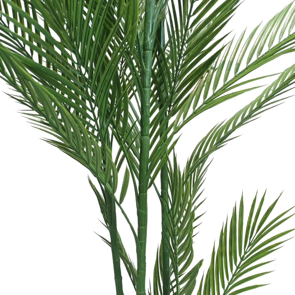 Artificial palm plant with green leaves on a white background