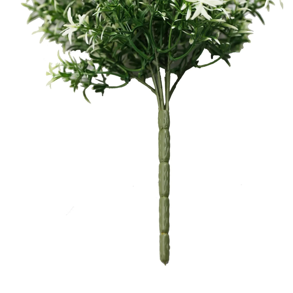 Artificial green plant with white flowers on a white background