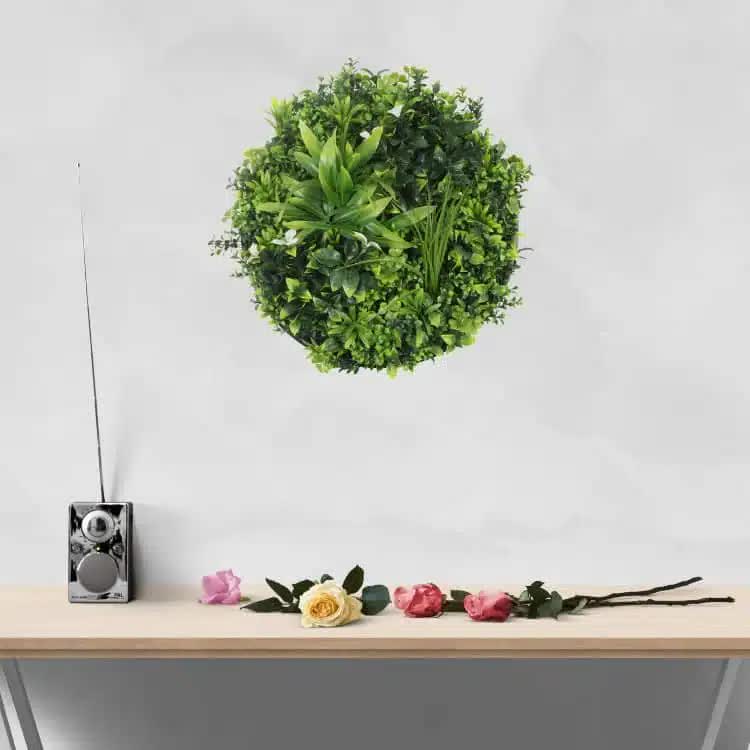 White artificial flowering green wall disc with black frame, UV resistant, 50cm, ideal for home and garden decorative wall displays.
