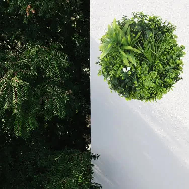 White flowering artificial green wall disc with black frame, UV resistant, 50cm, ideal for home and garden wall decor.