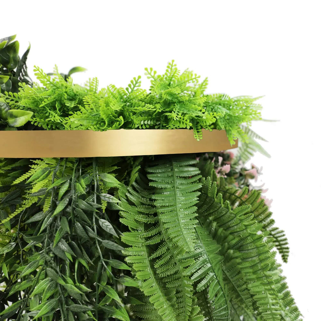 Artificial greenery with a gold shelf on a white background