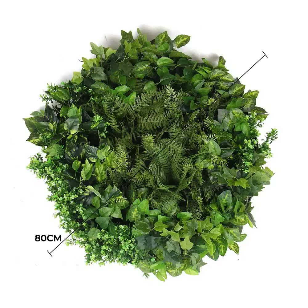 Artificial green wall disc art by Faux Flora featuring mixed fern and ivy on a modern black background, 80cm in size.