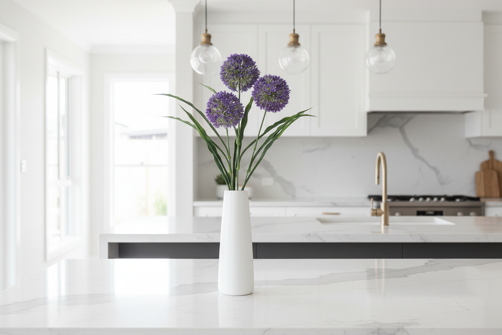 Kitchen – purple stems in white ceramic vase on marble island