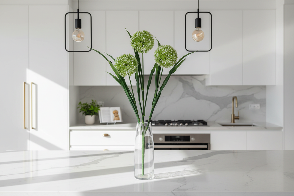 Kitchen – stems in clear glass vase on marble island